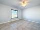 Well-lit bedroom featuring a ceiling fan and window at 8015 Idlebriar Ln, Port Richey, FL 34668