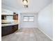 Bright dining area with tile flooring and view into kitchen at 8015 Idlebriar Ln, Port Richey, FL 34668