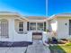 White single story home with a landscaped front yard and gated entry at 8015 Idlebriar Ln, Port Richey, FL 34668