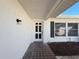 Front entryway of a home with white walls and a dark door at 8015 Idlebriar Ln, Port Richey, FL 34668