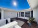 View of a home's entrance with a covered patio area at 8015 Idlebriar Ln, Port Richey, FL 34668
