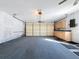 Garage with built-in cabinets and carpeted floor at 8015 Idlebriar Ln, Port Richey, FL 34668