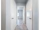 Clean hallway with neutral walls and tile flooring at 8015 Idlebriar Ln, Port Richey, FL 34668