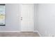 White interior door with six panels in a light gray room at 8015 Idlebriar Ln, Port Richey, FL 34668