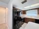 Black appliances and wood cabinets in this updated kitchen at 8015 Idlebriar Ln, Port Richey, FL 34668