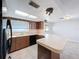 Updated kitchen with wood cabinets and black appliances at 8015 Idlebriar Ln, Port Richey, FL 34668