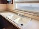 Clean kitchen with double sink and wood cabinets at 8015 Idlebriar Ln, Port Richey, FL 34668
