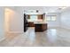 Bright kitchen features wood cabinets, black appliances, and tile floors at 8015 Idlebriar Ln, Port Richey, FL 34668