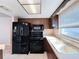 Updated kitchen with wood cabinets and black appliances at 8015 Idlebriar Ln, Port Richey, FL 34668