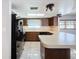 Modern kitchen with black appliances and wood cabinets at 8015 Idlebriar Ln, Port Richey, FL 34668
