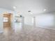 Open living room showcasing tile floors and views of the pool at 8015 Idlebriar Ln, Port Richey, FL 34668