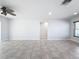 Spacious living room with tile flooring and ceiling fan at 8015 Idlebriar Ln, Port Richey, FL 34668