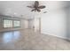 Bright living room with tile floors and sliding glass doors leading to the pool at 8015 Idlebriar Ln, Port Richey, FL 34668