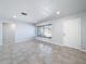 Spacious living room with tile floors and large windows at 8015 Idlebriar Ln, Port Richey, FL 34668