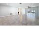 Living room with tile floors, ceiling fan, and kitchen access at 8015 Idlebriar Ln, Port Richey, FL 34668