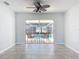Living area with sliding doors to the pool and tile flooring at 8015 Idlebriar Ln, Port Richey, FL 34668