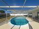 Relaxing kidney-shaped pool with screened enclosure at 8015 Idlebriar Ln, Port Richey, FL 34668