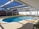 Inviting kidney-shaped pool with screened enclosure at 8015 Idlebriar Ln, Port Richey, FL 34668