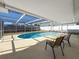 Inviting kidney-shaped pool with screened enclosure at 8015 Idlebriar Ln, Port Richey, FL 34668