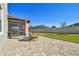Relaxing backyard patio with paver stones, wooden chairs, and an umbrella at 8144 Sequester Loop, Land O Lakes, FL 34637