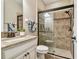 Bathroom with granite countertop, a shower, and white cabinetry at 8144 Sequester Loop, Land O Lakes, FL 34637
