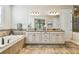 Elegant bathroom with double vanity, soaking tub, and tile flooring at 8144 Sequester Loop, Land O Lakes, FL 34637