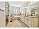 Spa-like bathroom with double vanity, soaking tub, and tile flooring at 8144 Sequester Loop, Land O Lakes, FL 34637