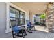 Peaceful front porch with rocking chairs and a view of the landscaping at 8144 Sequester Loop, Land O Lakes, FL 34637