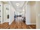 Long hallway with hardwood floors leading to various rooms at 8144 Sequester Loop, Land O Lakes, FL 34637