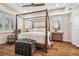 Spacious main bedroom with a large four poster bed, hardwood floors and a ceiling fan at 8144 Sequester Loop, Land O Lakes, FL 34637