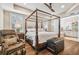 Main bedroom with king-size bed, massage chair, and ensuite bathroom access at 8144 Sequester Loop, Land O Lakes, FL 34637