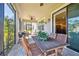 Relaxing screened porch with patio furniture and view of backyard at 8144 Sequester Loop, Land O Lakes, FL 34637