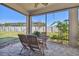 Spacious screened-in porch with wooden patio furniture at 8144 Sequester Loop, Land O Lakes, FL 34637