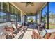 Enjoy this screened porch with wooden seating and a ceiling fan at 8144 Sequester Loop, Land O Lakes, FL 34637