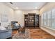 Elegant sitting area with hardwood floors, comfortable armchairs, and built-in shelves at 8144 Sequester Loop, Land O Lakes, FL 34637