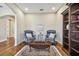 Cozy sitting room with two armchairs, a coffee table, and a bookcase at 8144 Sequester Loop, Land O Lakes, FL 34637