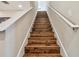 Elegant wooden staircase with white railings leading to the upper level at 8144 Sequester Loop, Land O Lakes, FL 34637