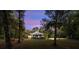 Circular home with a covered carport, surrounded by trees at 8356 Owls Roost Ln, Brooksville, FL 34601