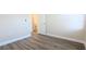 Bright bedroom with wood-look flooring and access to a bathroom at 9060 Moonlit Meadows Loop, Riverview, FL 33578