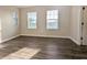 Spacious bedroom with wood-look floors and two windows at 9060 Moonlit Meadows Loop, Riverview, FL 33578