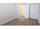 Spacious bedroom with wood-look floors and an attached bath at 9060 Moonlit Meadows Loop, Riverview, FL 33578
