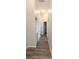 Hallway with wood-look floors and laundry closet at 9060 Moonlit Meadows Loop, Riverview, FL 33578