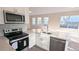 Modern kitchen with island and stainless steel appliances at 9060 Moonlit Meadows Loop, Riverview, FL 33578