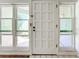 White front door with multiple panels and sidelights at 10626 Longwood Dr # 103, Seminole, FL 33777