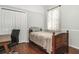 Small bedroom with a twin bed, a small desk, and wood floors at 10714 Tavistock Dr, Tampa, FL 33626