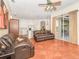 Gathering room with leather recliners, ceiling fan, and access to the pool area at 10714 Tavistock Dr, Tampa, FL 33626