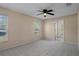 Spacious bedroom with carpet flooring and ceiling fan at 11262 Sneeze Rd, Brooksville, FL 34614