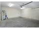 Garage with concrete floor, an overhead door, and extra storage space at 11262 Sneeze Rd, Brooksville, FL 34614