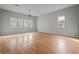 Large bedroom with hardwood floors and multiple windows at 1321 Riverside Dr, Tarpon Springs, FL 34689