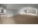 Spacious bonus room with carpeted floor and brick accent wall at 1321 Riverside Dr, Tarpon Springs, FL 34689